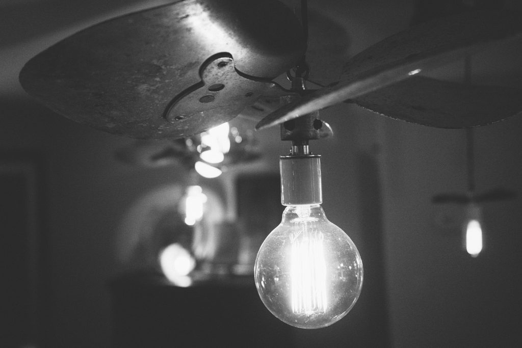 When did light bulbs become common - black and white hanging bulb